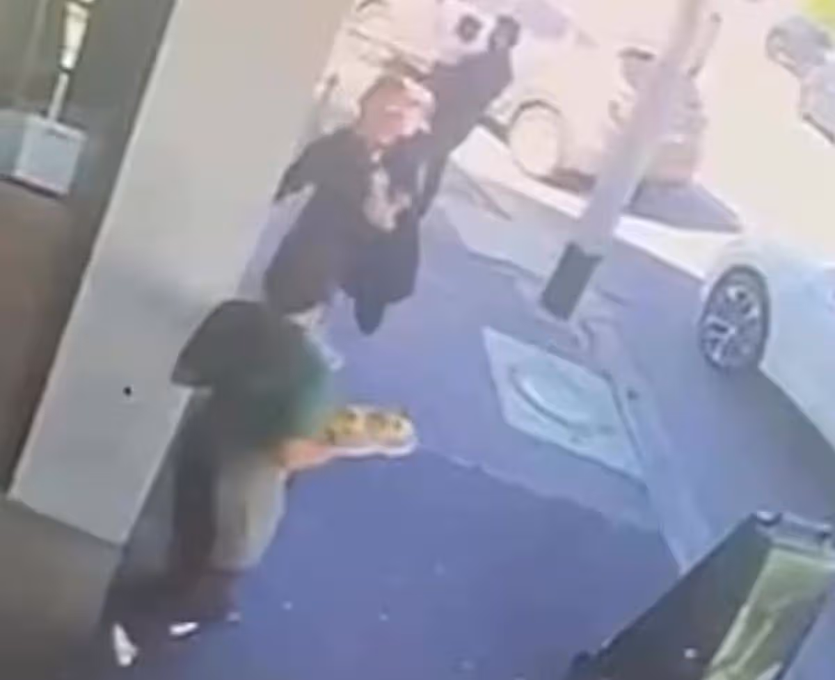 A cafe worker (above) in north Melbourne suffered a chipped tooth after a cruel passerby shoved a plate into her face
