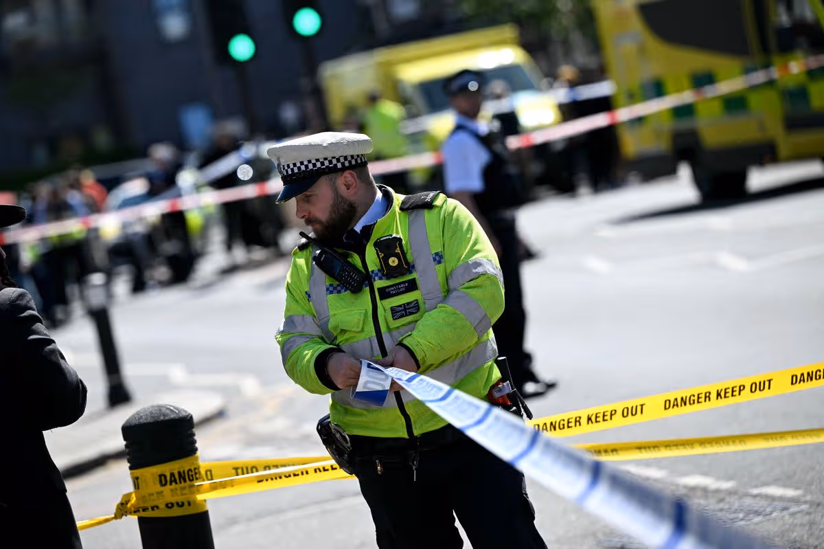 A photo of police following the stabbing