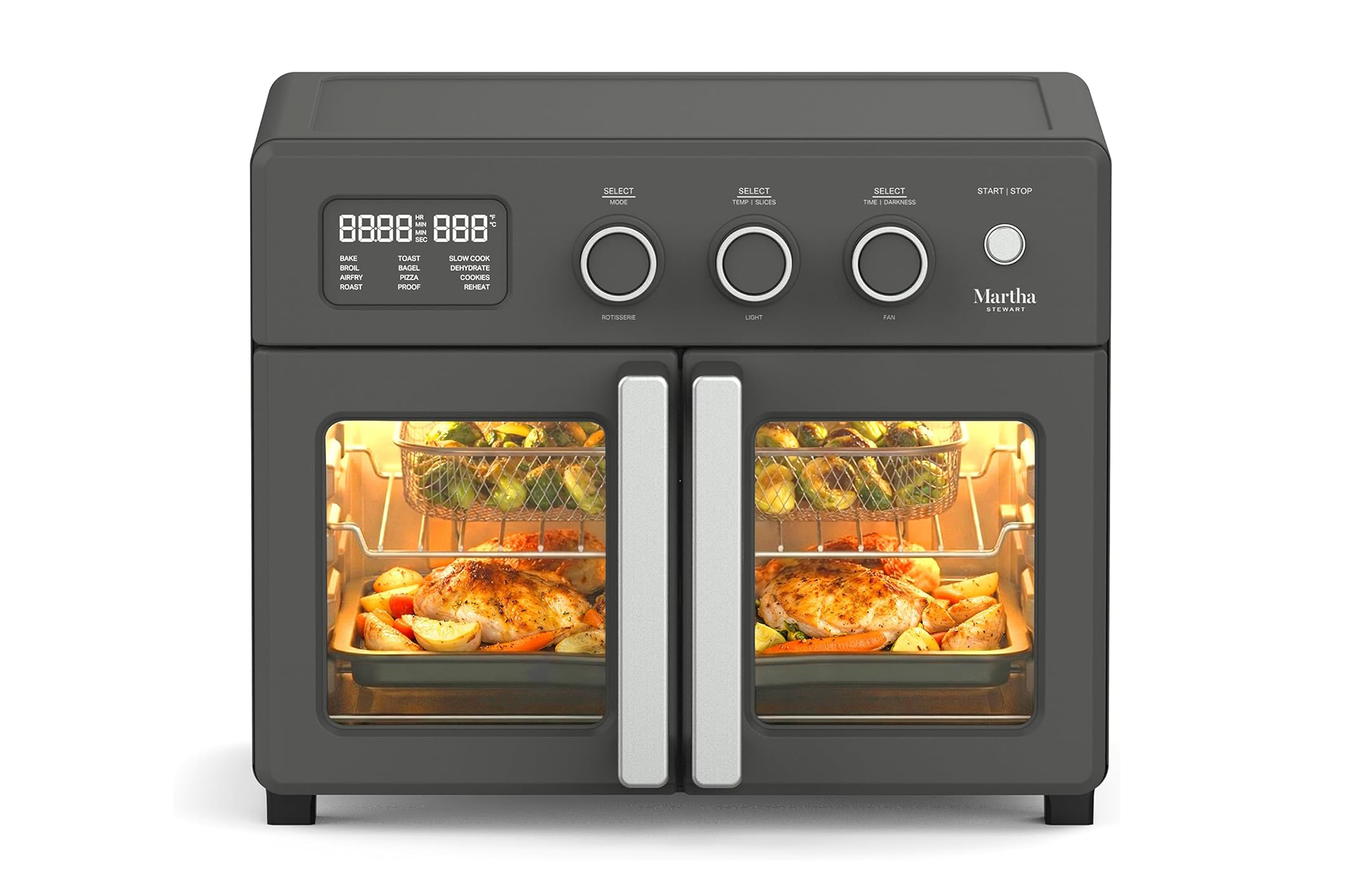 Illustration of a dark gray Martha Stewart air fryer with a digital display and three control knobs, cooking chicken and vegetables.