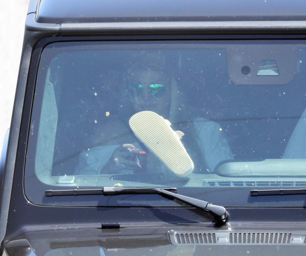 Britney Spears with her feet on the dashboard of a Mercedes G-Wagon.