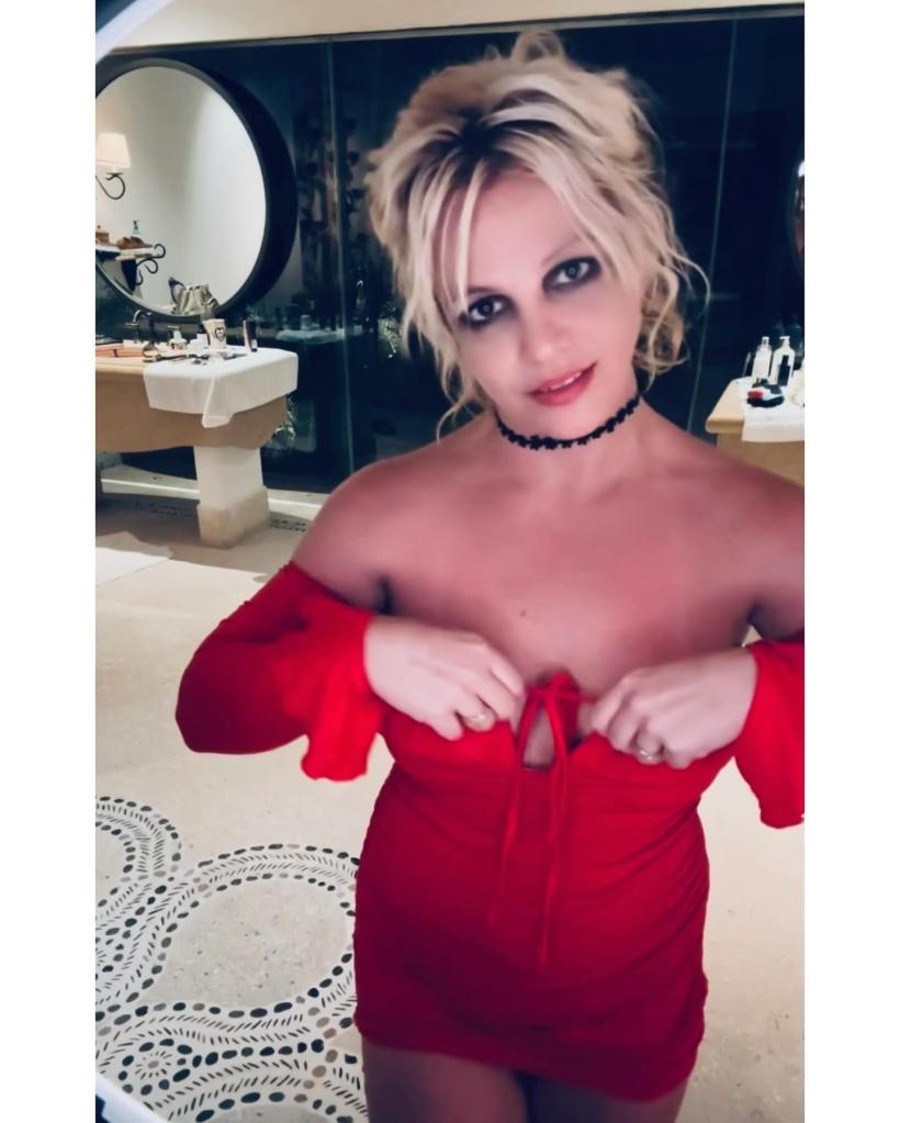 Britney Spears in a red dress with a black choker.