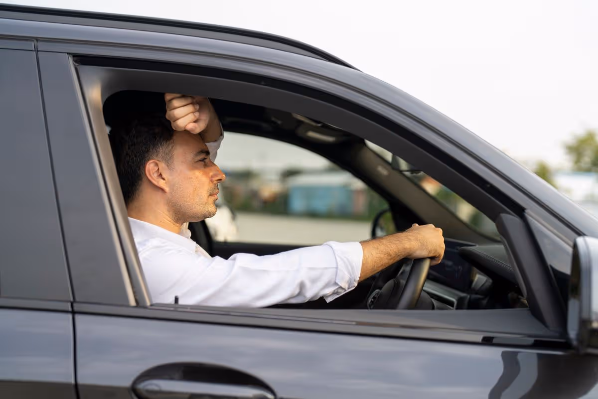 man drive car feeling sad and angry.