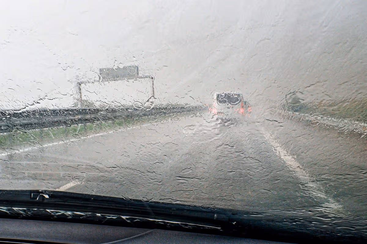 Driving very slowly on a highway in a heavy rainstorm. Two-lane highway from Madrid to La Coruña. Spain, Europe.