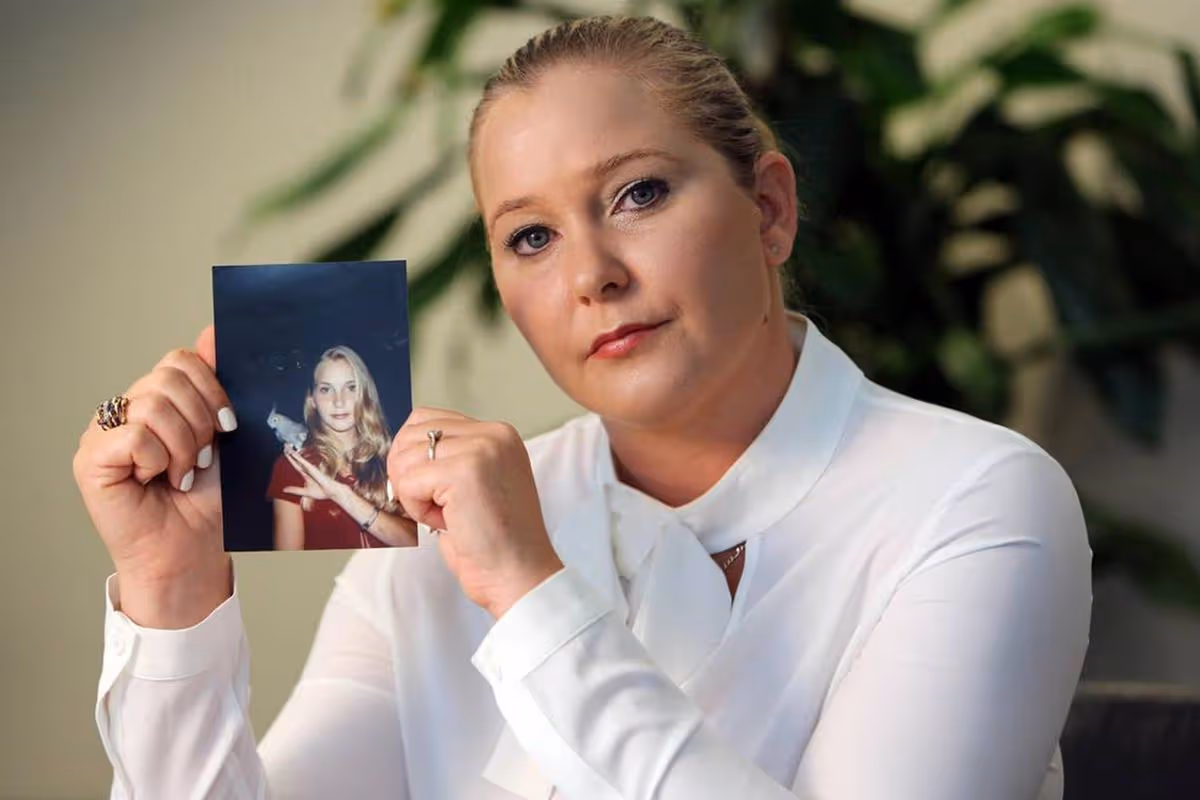 Virginia Giuffre, with a photo of herself as a teen, when she says she was abused by Jeffrey Epstein, Ghislaine Maxwell and Prince Andrew, among others. (Emily Michot/Miami Herald/Tribune News Service via Getty Images)