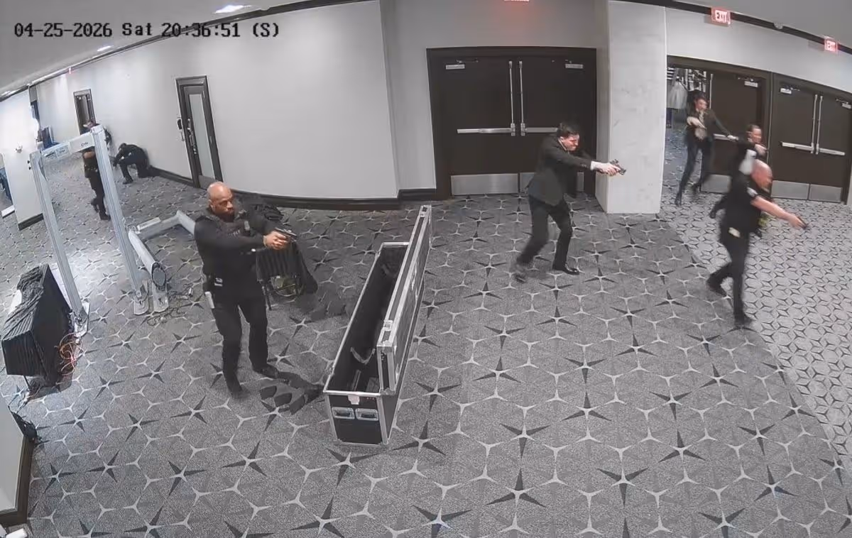 Officers point their firearms at the alleged gunman who is not seen in this still