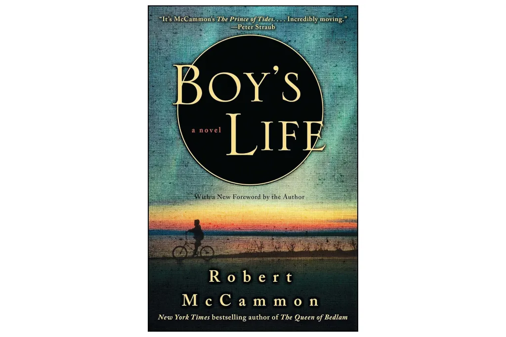 Book cover for Robert McCammon's novel, "Boy's Life," featuring a silhouette of a boy on a bicycle by a lake at sunset.