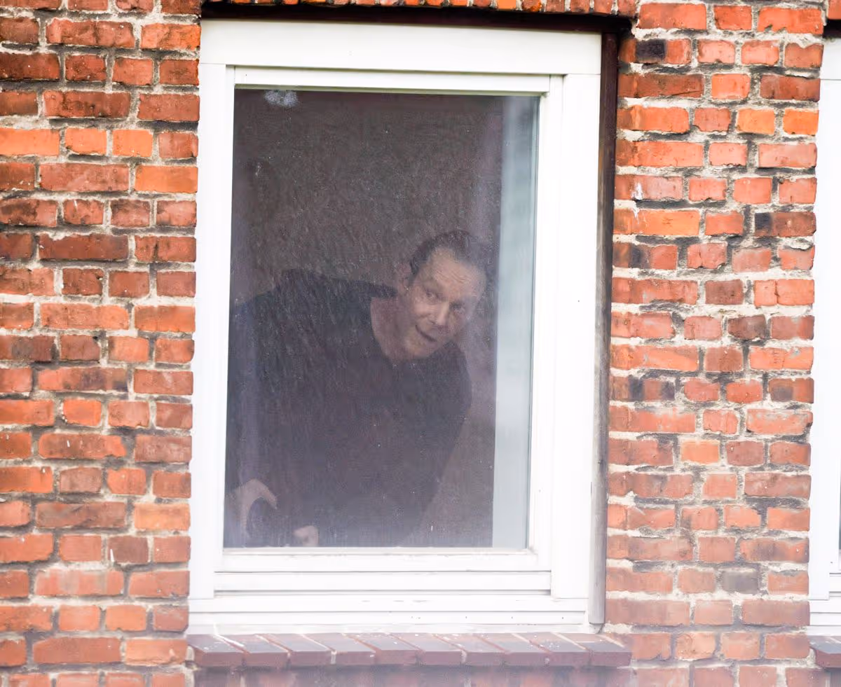 Christian Brueckner looking out of a window from one of his hideouts