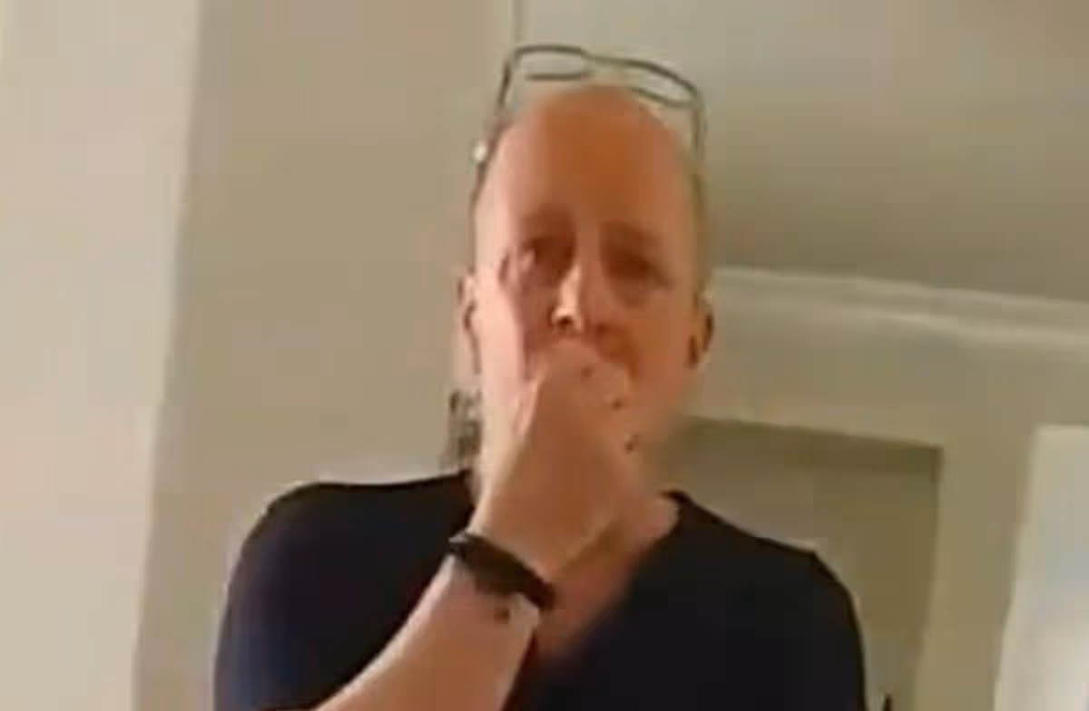 Kris Harrison covering his mouth