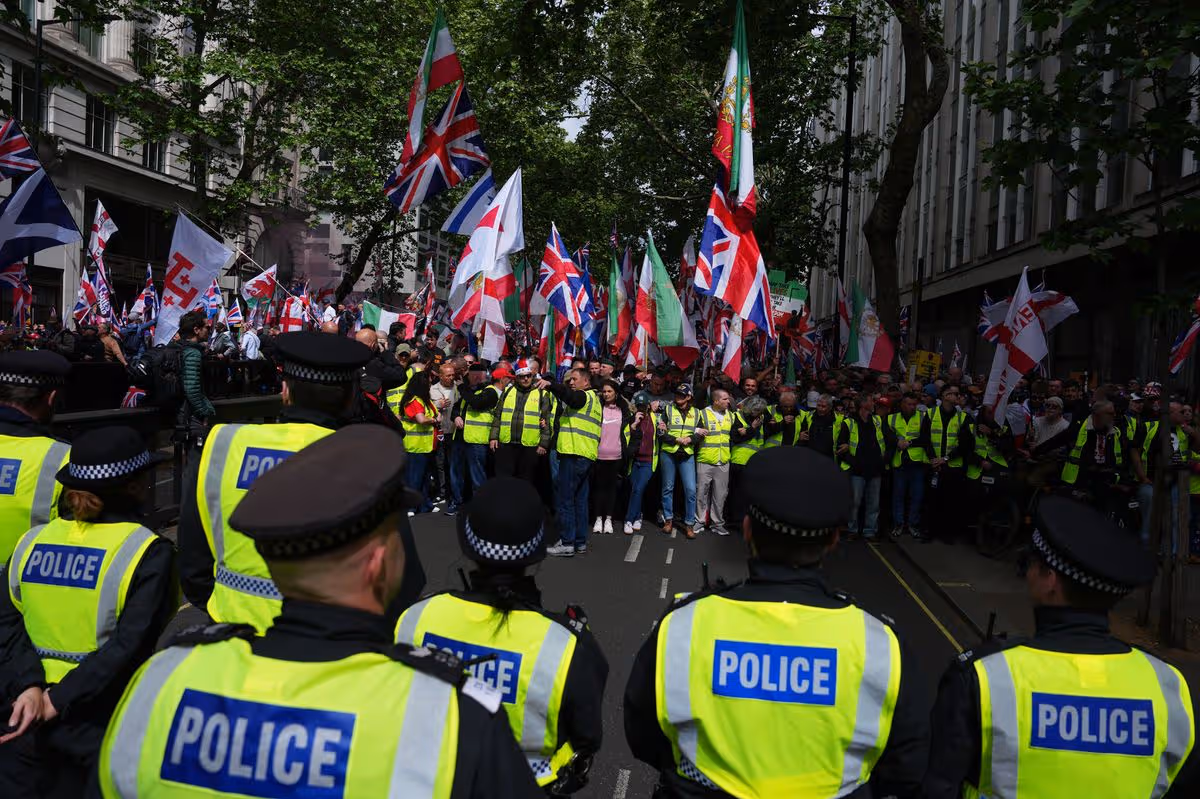 Police monitor the situation a people take part in a Unite The Kingdom protest