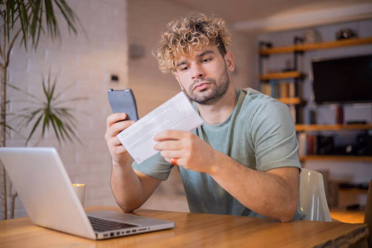 Man planning home budget and using calculator