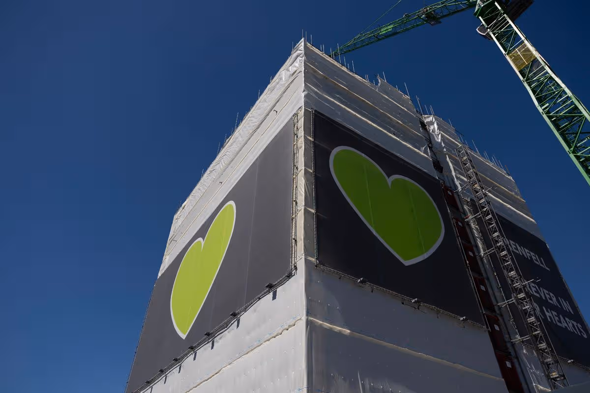 Grenfell Tower with a crane above it