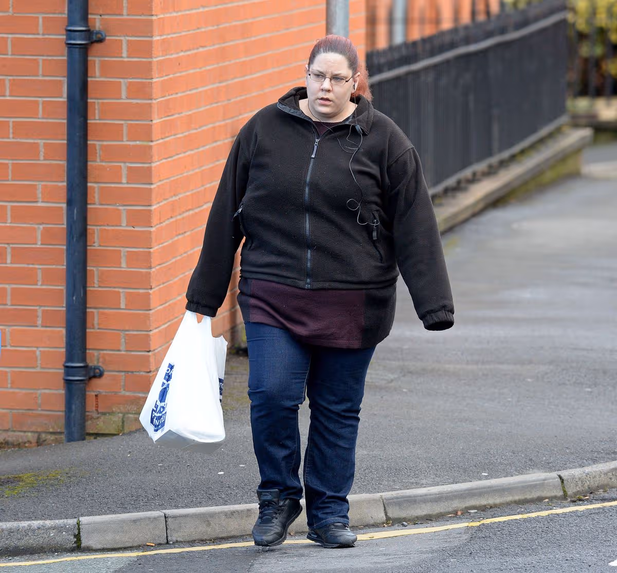 Tracey Connelly, the infamous mother of baby P, leaving the Women's bail hostel in the North of England, after her release from prison, sporting her newly dyed red hair, as she pops out for 5 minutes