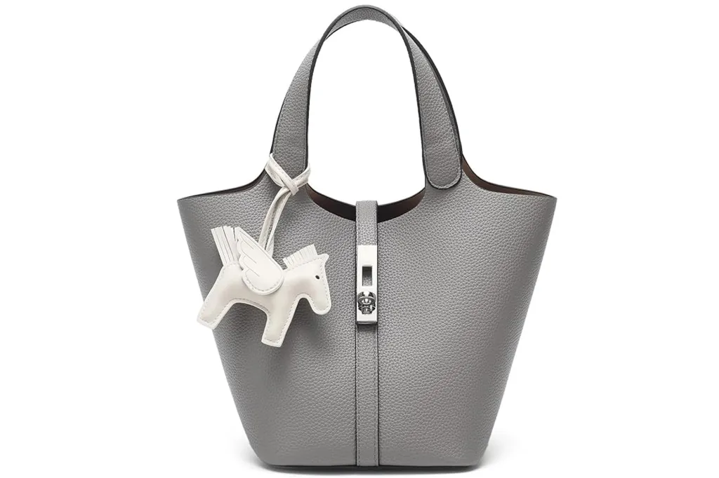 Gray bucket-style handbag with a white winged horse charm.