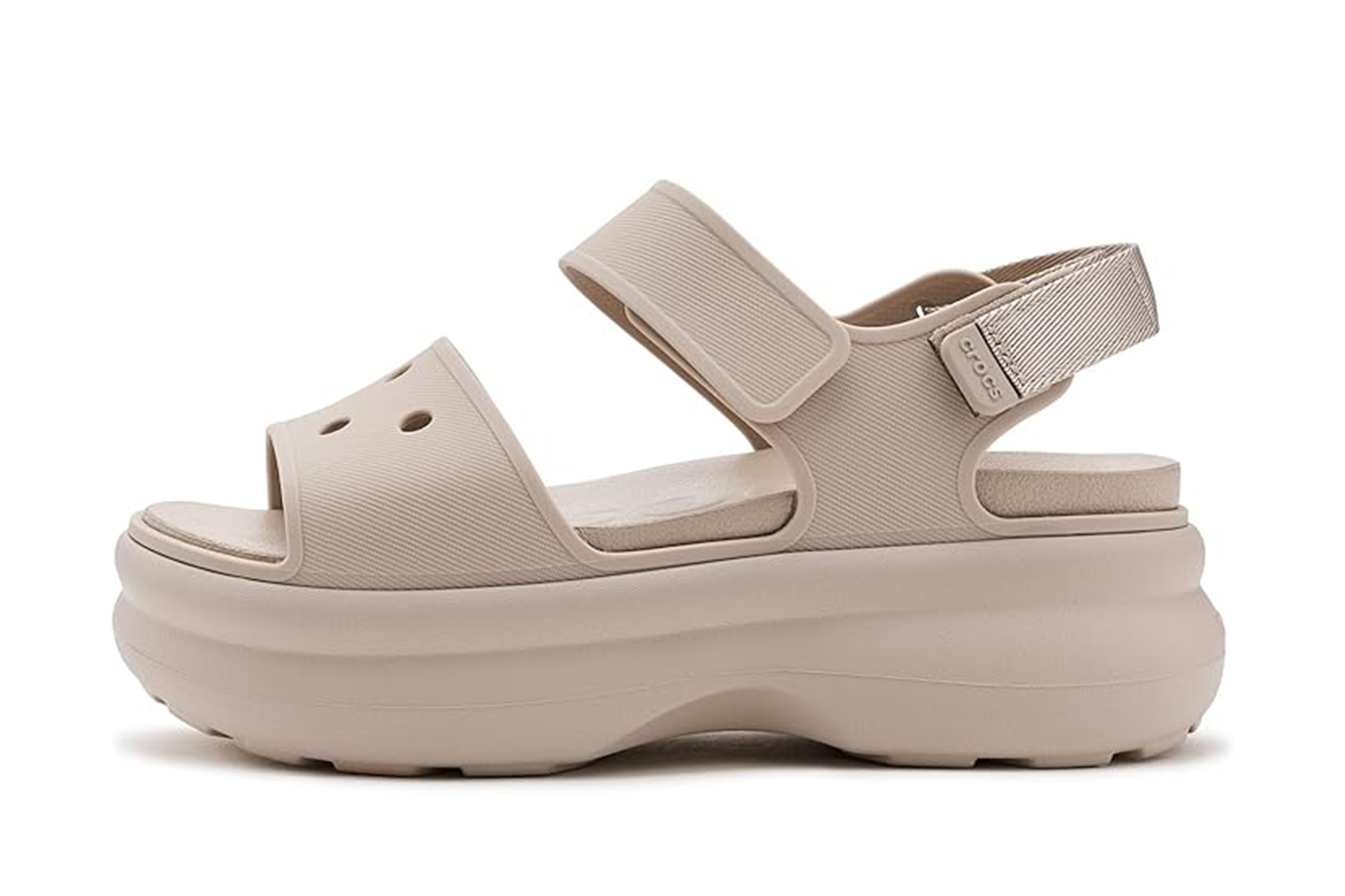 Side view of a single beige Crocs platform sandal with a textured strap and ankle strap.