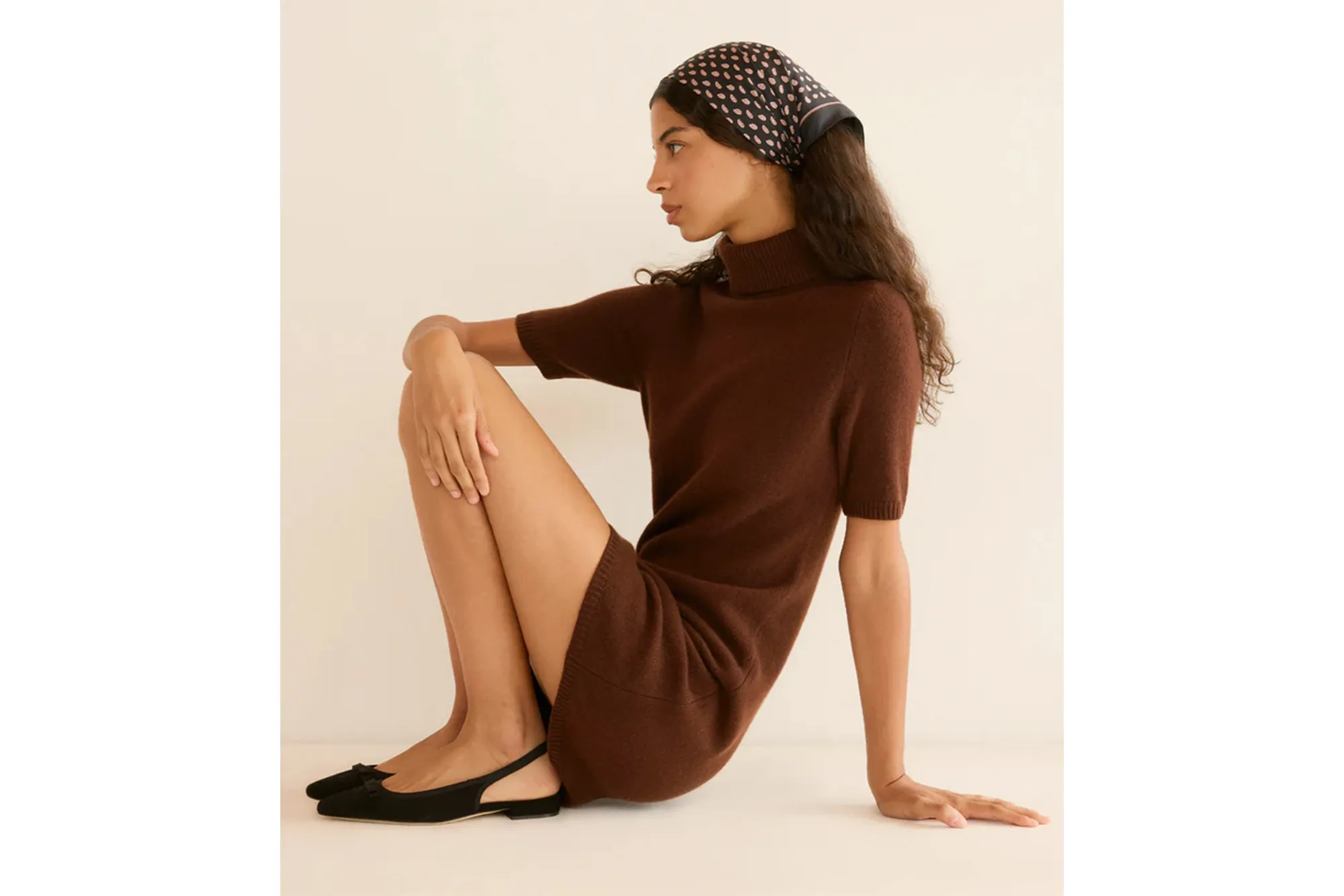 Model wearing a brown Agathe Cashmere Dress with short sleeves, a turtleneck, and a patterned headscarf.