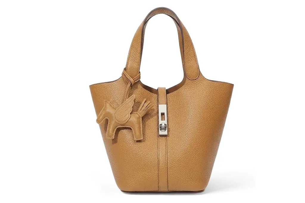 Tan leather handbag with a Pegasus charm.