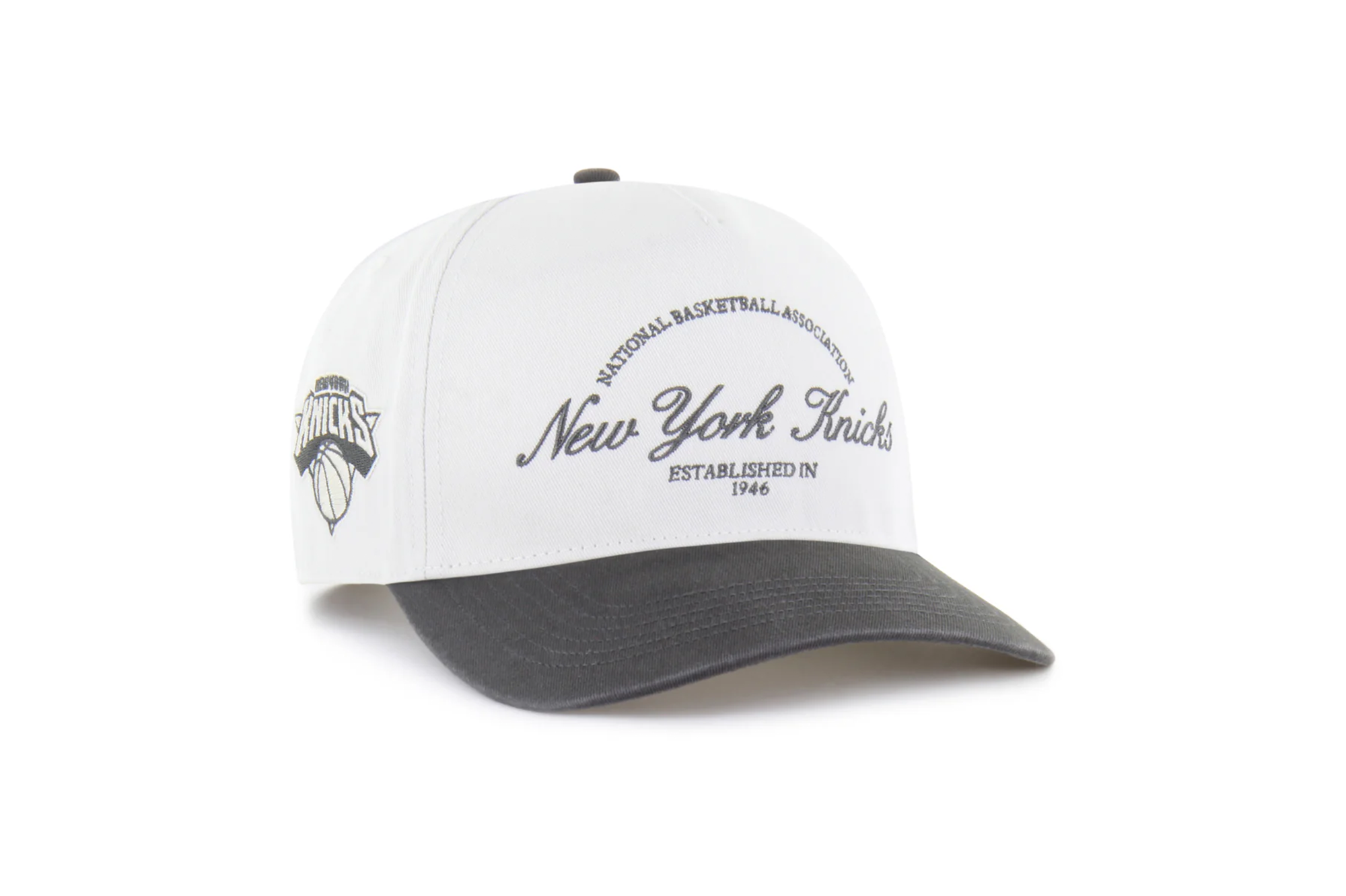 White baseball cap with a dark gray brim, featuring "New York Knicks" and "Established in 1946" embroidered on the front.