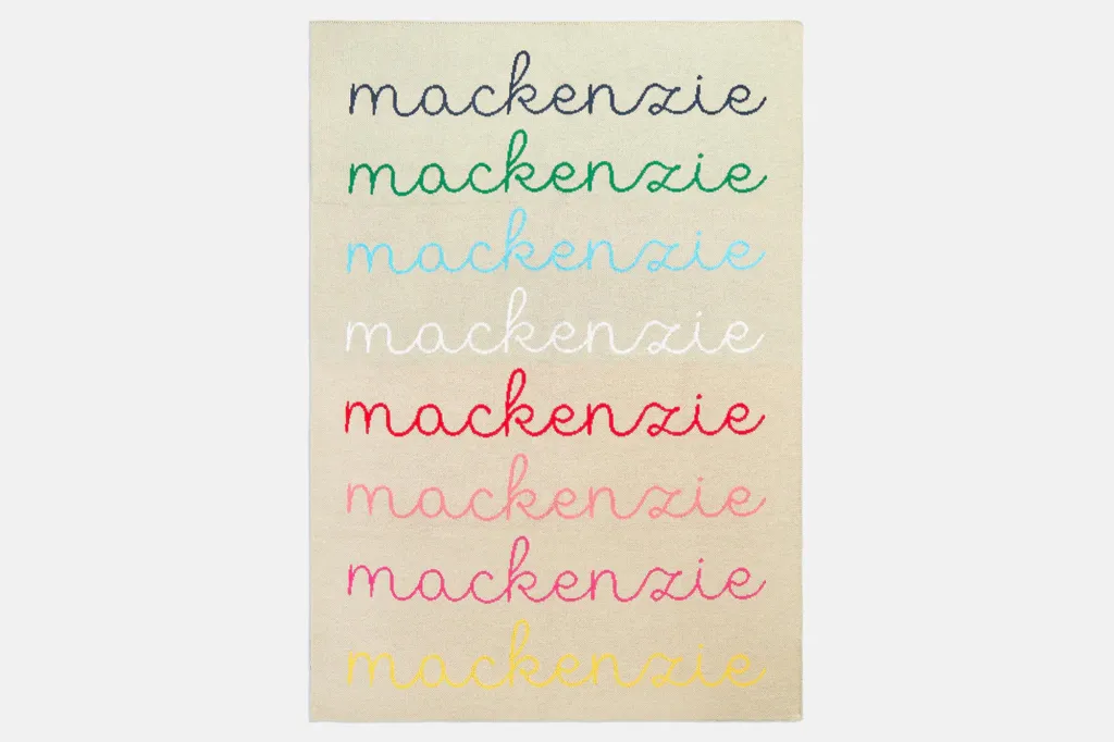 A rug with "mackenzie" embroidered in eight different colors.