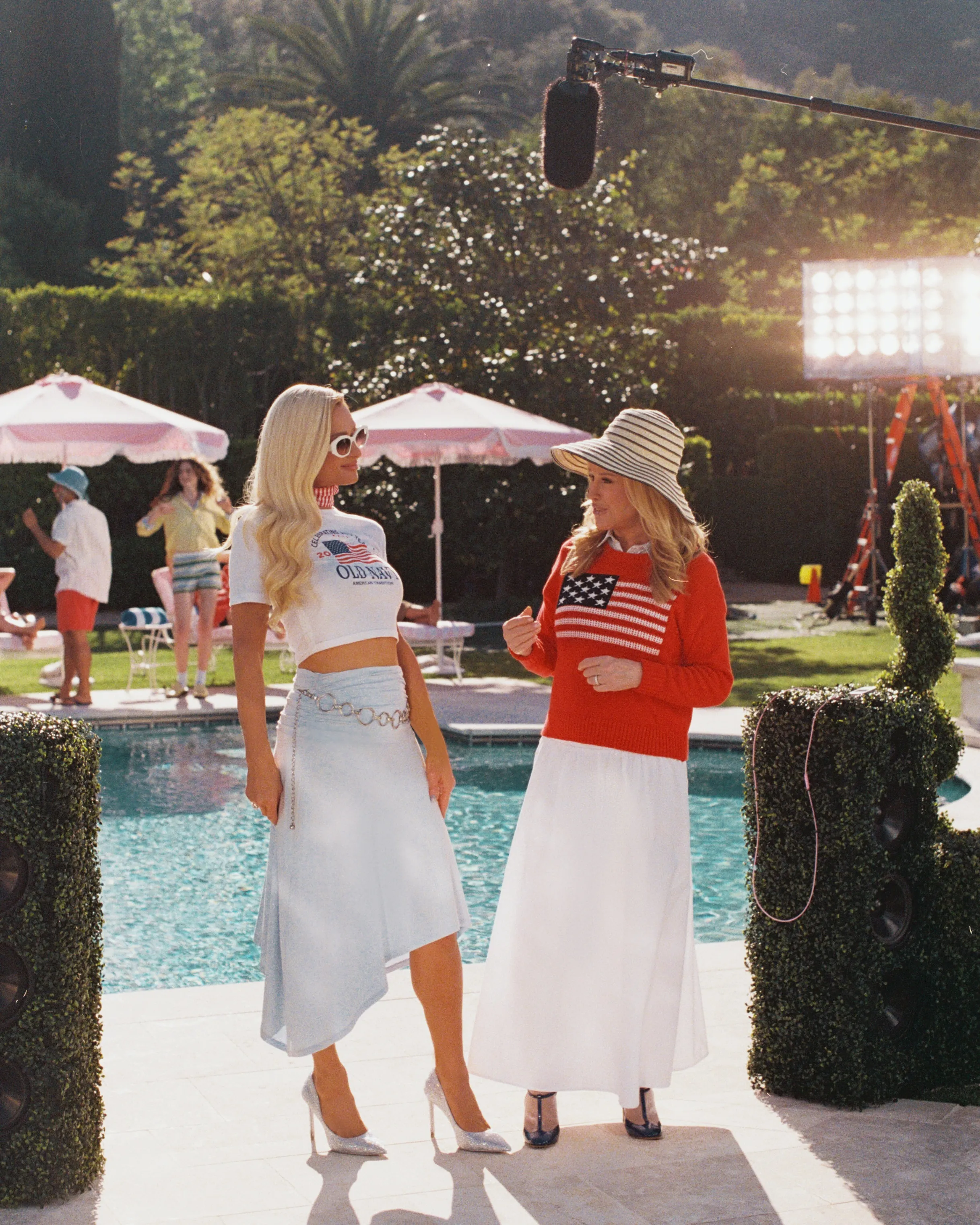Paris Hilton and Kathy Hilton standing poolside during a photoshoot for Old Navy.