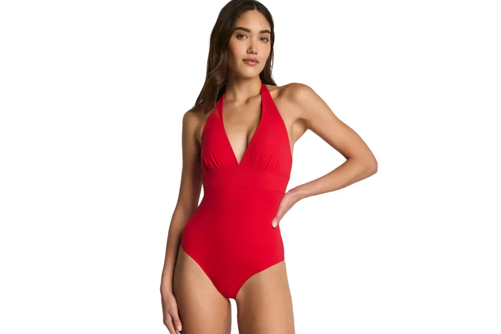 Woman wearing a red halterneck swimsuit.