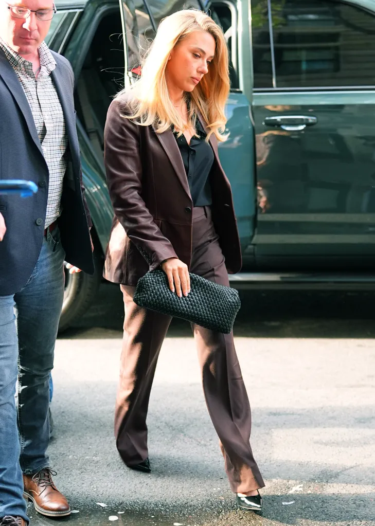 Scarlett Johansson seen wearing a brown suit and black shirt.