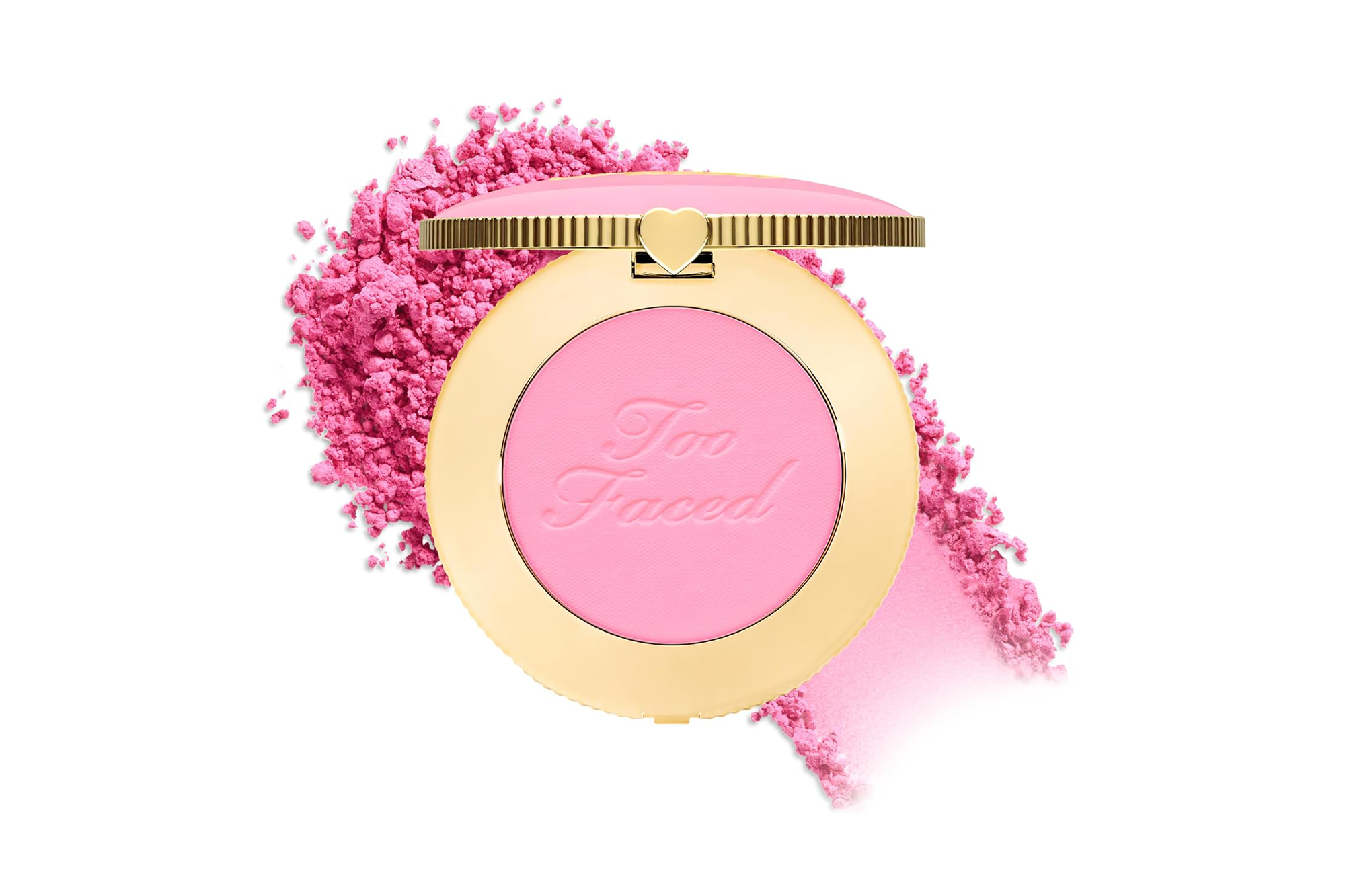 Too Faced blush in a gold compact against a background of loose pink powder.