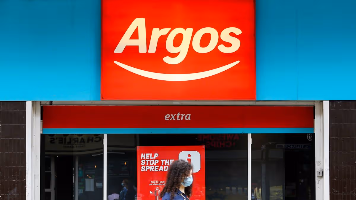 1_A-woman-wearing-a-face-mask-walks-past-a-branch-of-Argos-in.jpg