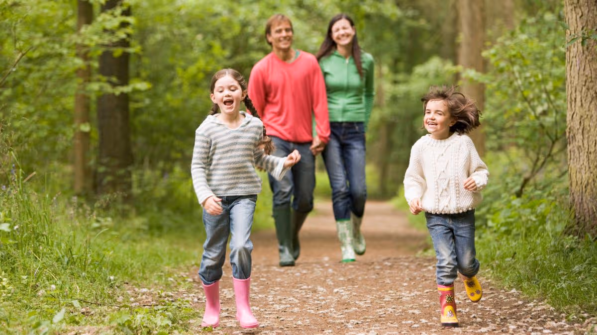 1_Family-walking-on-path-holding-hands-smiling.jpg