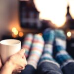 0_Couple-drinking-tea-hot-chocolate-eggnog-or-mulled-wine-and-watching-tv-in-warm-cozy-woolen-socks.jpeg