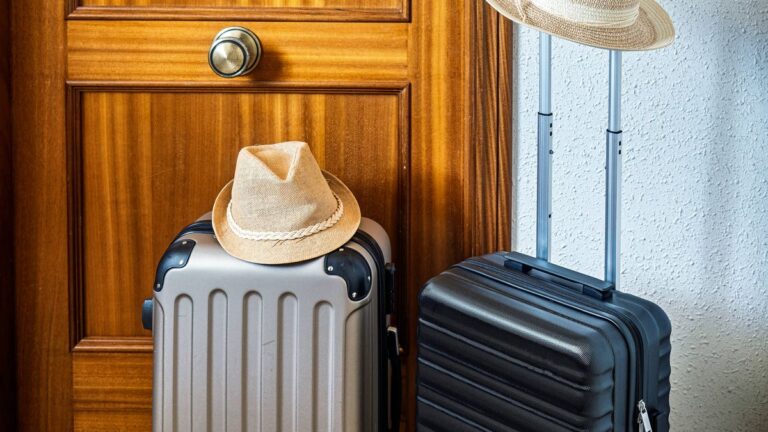 1774155762_0_Two-carry-on-suitcases-and-two-hats-next-to-the-entrance-door-of-a-tourist-rental-apartment.jpg