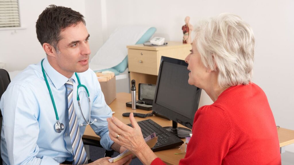 1774505687_0_British-GP-talking-to-senior-woman-in-surgery.jpg