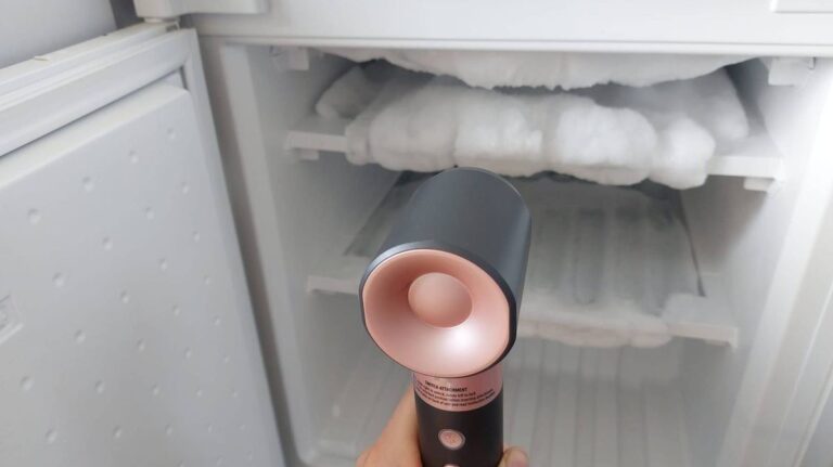 1774656735_0_person-defrosting-freezer-with-hair-dryer.jpg