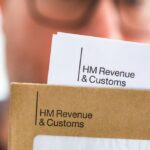 1774866171_0_Mid-adult-man-opening-HMRC-tax-letter.jpg