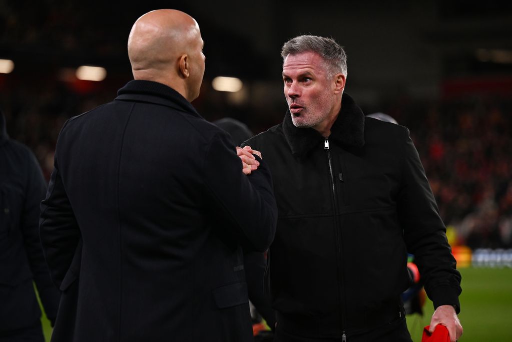 Arne Slot, Manger of Liverpool, shakes hands with Jamie Carragher, former Liverpool player and TV pundit for Amazon Prime prior to the UEFA Champions League 2024/25 Round of 16 Second Leg match between Liverpool FC and Paris Saint-Germain