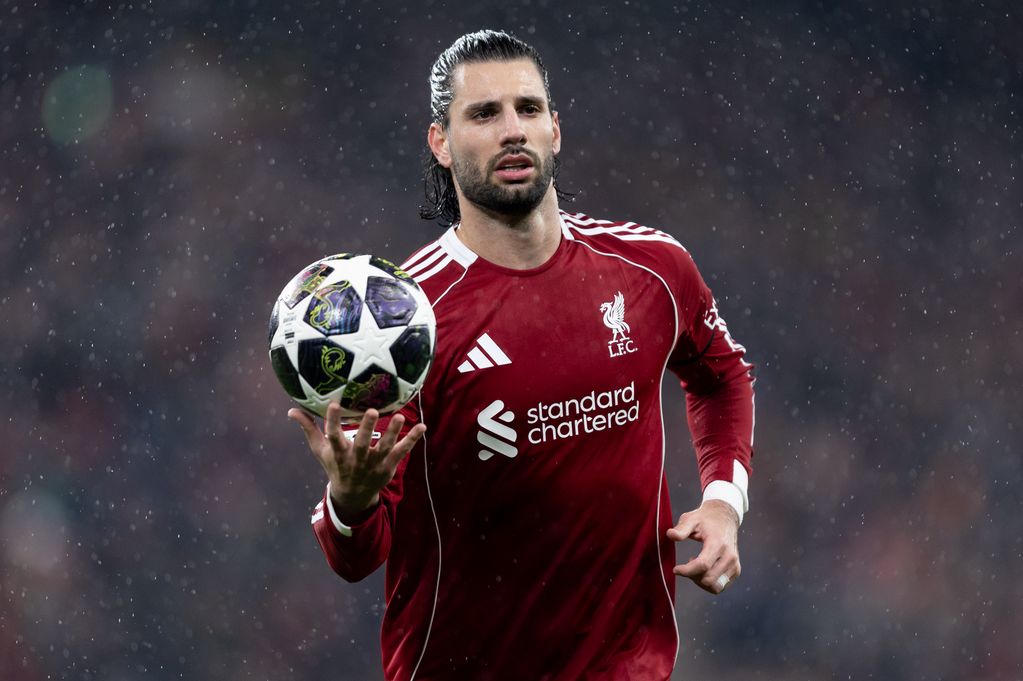 Dominik Szoboszlai of Liverpool holds the Champions League ball