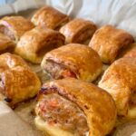 1775632573_0_Freshly-baked-sausage-rolls-on-grease-proof-paper-in-a-baking-tray.jpg
