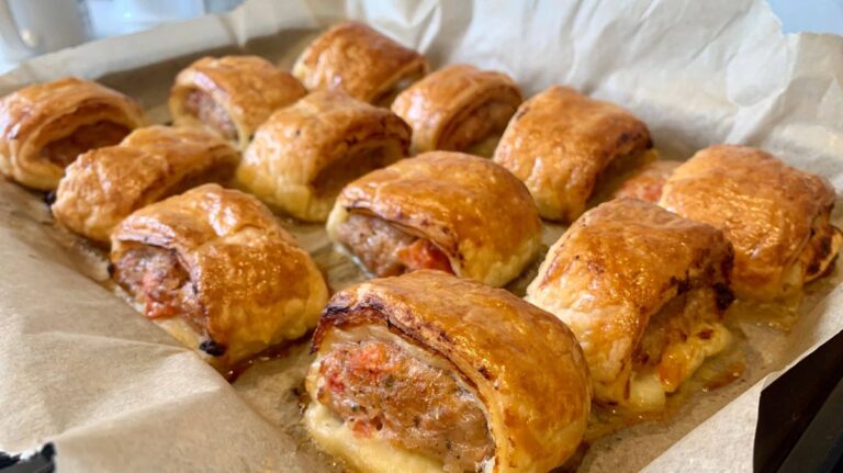 1775632573_0_Freshly-baked-sausage-rolls-on-grease-proof-paper-in-a-baking-tray.jpg