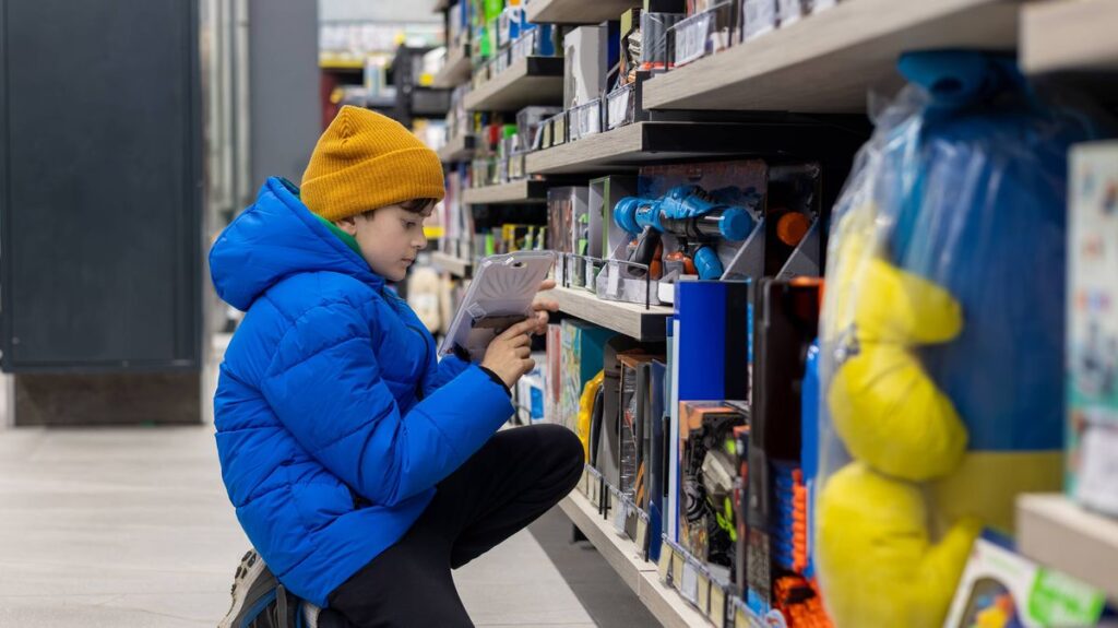 1775800793_0_Boy-Choosing-a-Toy-in-Supermarket-Toy-Aisle-During-Shopping.jpg