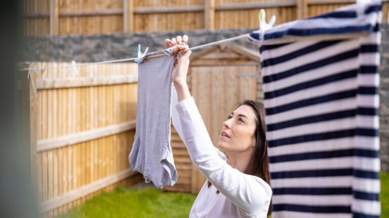 1776319569_0_Woman-hanging-up-laundry-outside-house.jpg