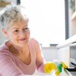 1776562180_0_Front-view-of-senior-woman-indoors-at-home-cleaning-kitchen.jpg