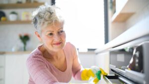 1776562180_0_Front-view-of-senior-woman-indoors-at-home-cleaning-kitchen.jpg