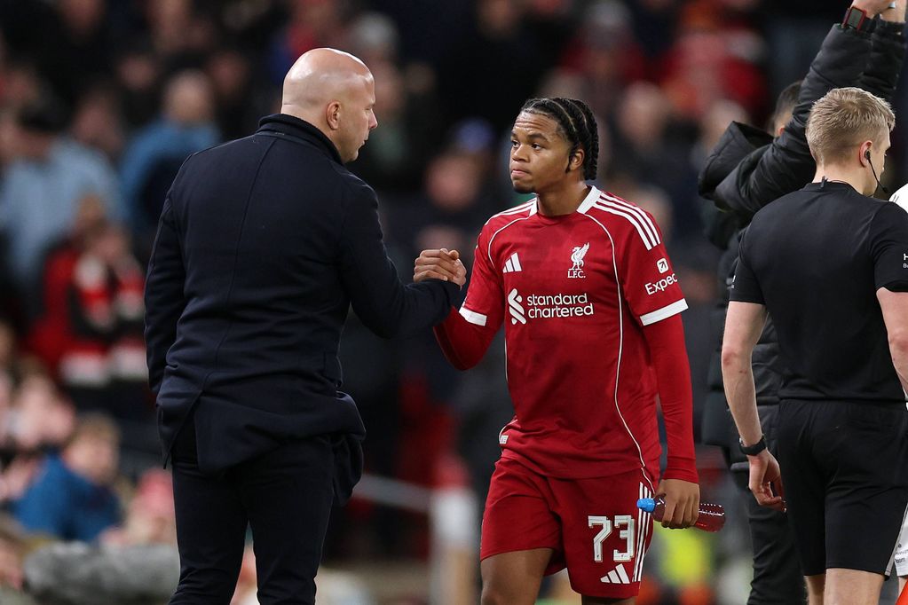 Rio Ngumoha of Liverpool shakes hands with Arne Slot, Manager of Liverpool, after being substituted having suffered a leg injury during the Emirates FA Cup Third Round match between Liverpool and Barnsley