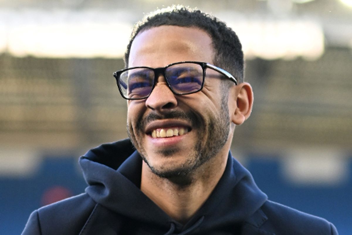 Liam Rosenior smiling while walking around on the Amex Stadium pitch